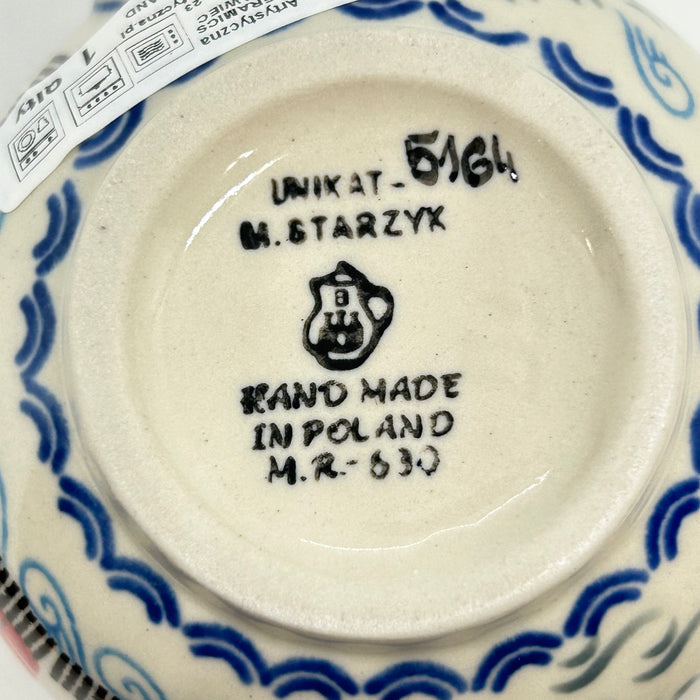 Bottom of an 11oz Ceramika Artystyczna Polish pottery bubble mug showing Unikat 5164 , M. Starzyk artist name, Ceramika Artystyczna's logo, and 1st Quality sticker