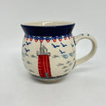 Front view of an 11oz Ceramika Artystyczna Polish pottery bubble mug in the Unikat U5164 pattern, featuring a hand-painted red lighthouse.