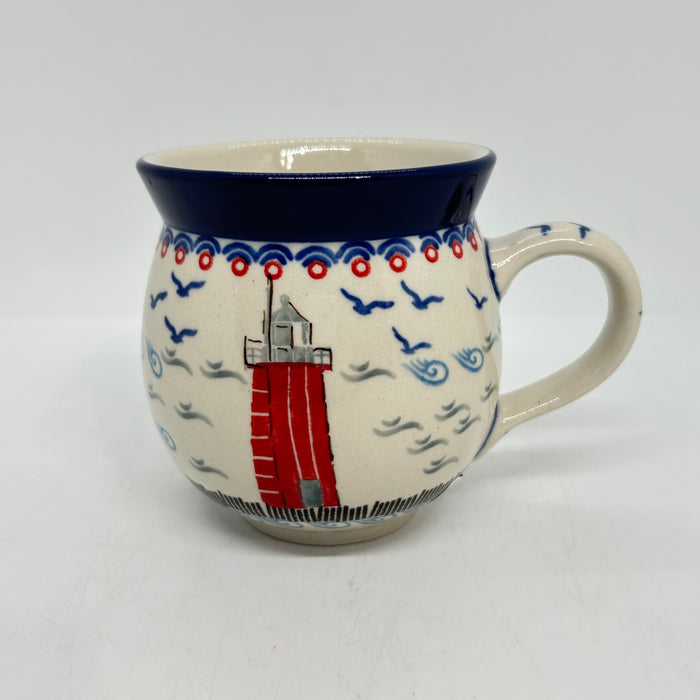 Front view of an 11oz Ceramika Artystyczna Polish pottery bubble mug in the Unikat U5164 pattern, featuring a hand-painted red lighthouse.