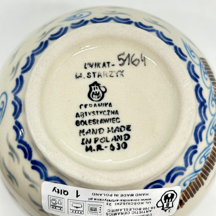 Bottom of a large 16oz Ceramika Artystyczna Polish pottery bubble mug showing Unikat 5164, M. Starzyk artist signature,  Ceramika Artystyczna factory logo, and a 1st Quality sticker.