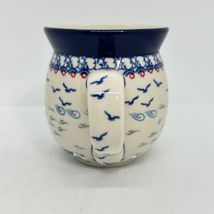 Close-up of the handle on a large 16oz Ceramika Artystyczna bubble mug in the Unikat U5164 pattern, showing the blue lip, and birds.
